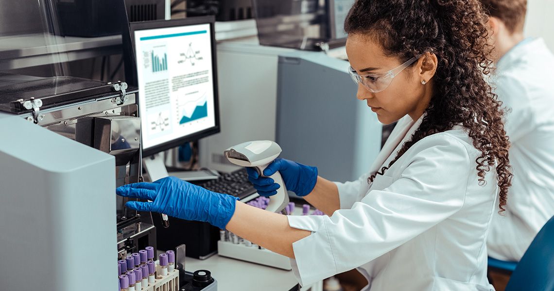 Medical laboratory scientist examining specimens in a lab.