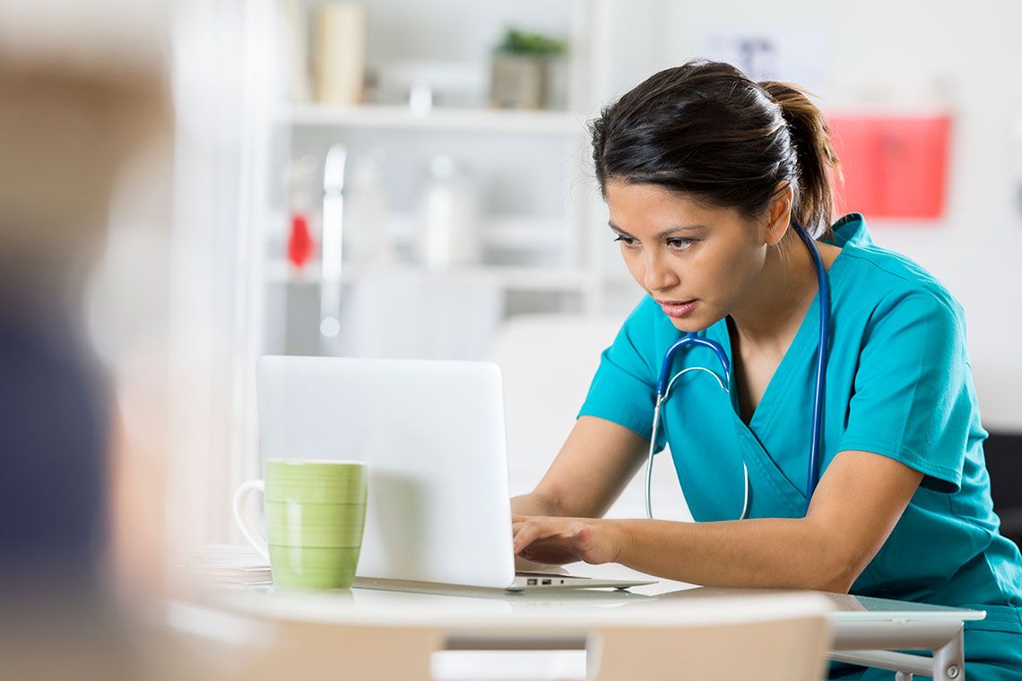 A nurse working at a computer