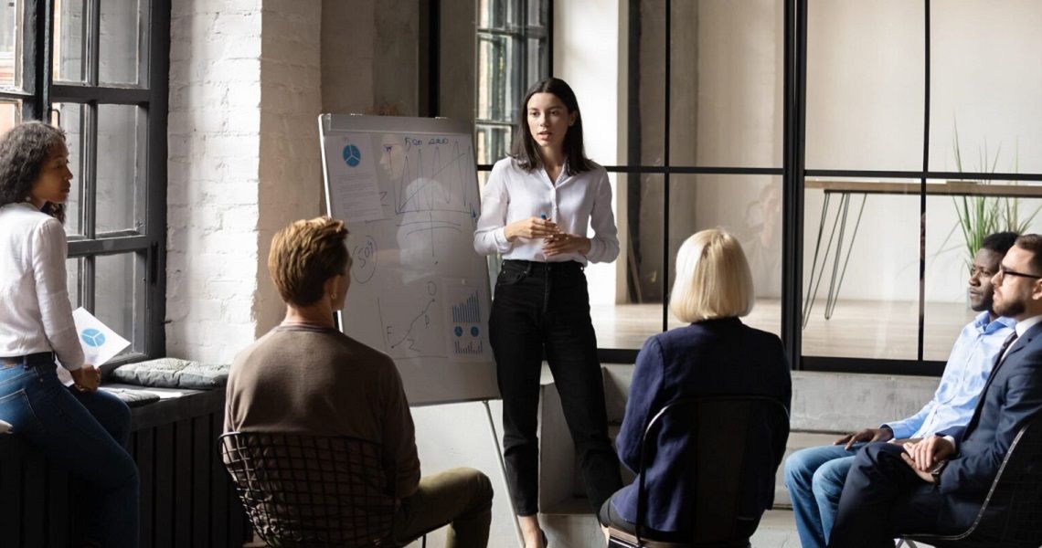 A woman gives a presentation in front of a group of people