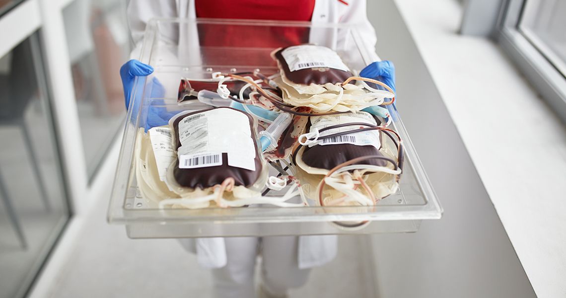 someone walking with a tray of blood bags