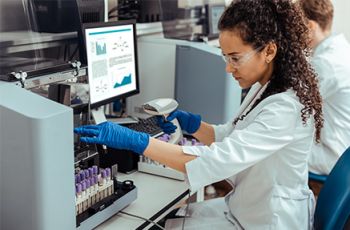 Medical laboratory scientist examining specimens in a lab.