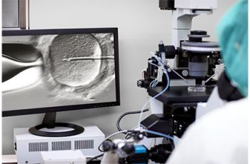 Embryologist using specialized equipment to fertilize an egg.